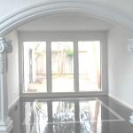 Formal dining room with view of side courtyard is open to formal