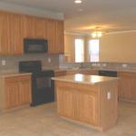 Kitchen is open to living area.  Features solid surface counter