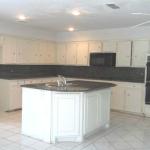 Kitchen has lots of counter space and large island with granite